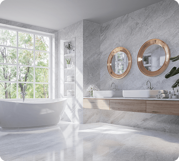 Modern bathroom with a freestanding tub, two round mirrors, double sinks, and a large window. Light gray marble surfaces and minimalist decor create an elegant atmosphere.