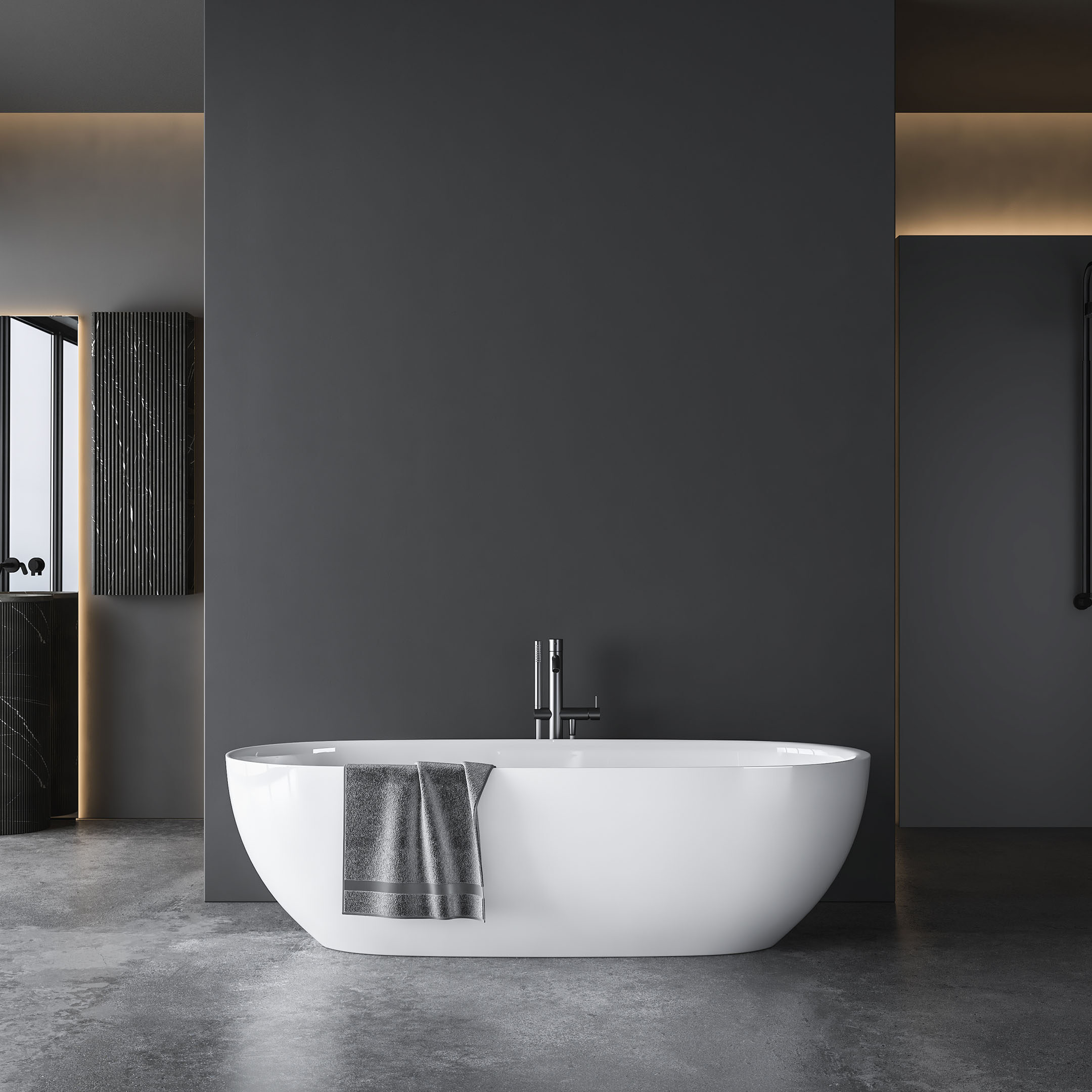 A modern bathroom with a freestanding white bathtub against a dark gray wall. A towel hangs on the tub's edge, and natural light enters through a window.